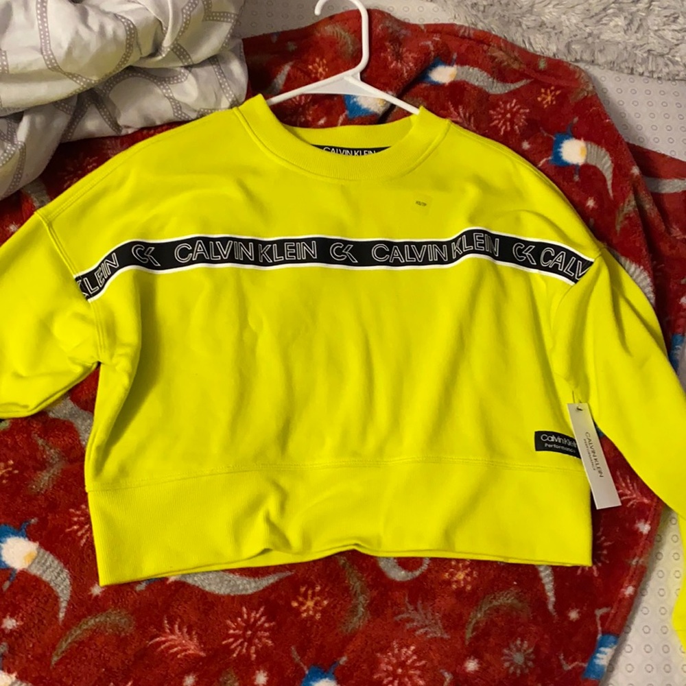 Neon yellow cropped Calvin Klein sweater.